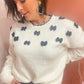 Pull blanc avec nœuds papillon
